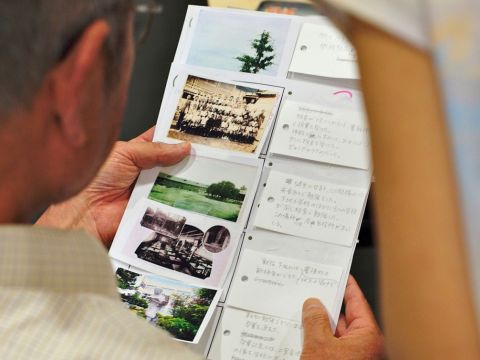 A senior local resident was checking his story about the memories during the Pacific War, before inputting his pictures and voice into a PC. Photograph by the author.