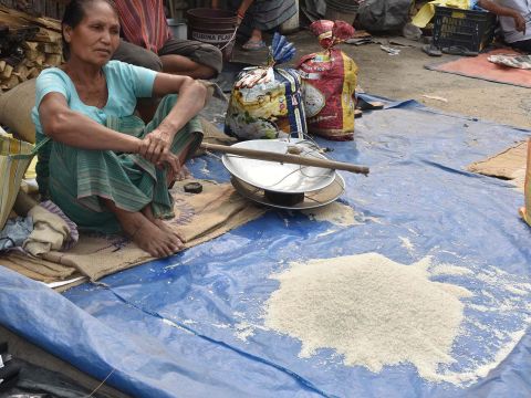 Boro woman selling home produced rice at the weekly market