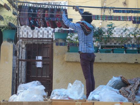 Vendor setting up shop in front of a residence, Shadipur Shani Bazaar, 2015, Photo by: Shorbori Purkayastha