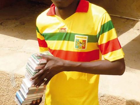 Sékou Maïgo, our HaB assistant in data collecting, holding a stack of cassettes entrusted to me by Radio station Fitilla for digitization