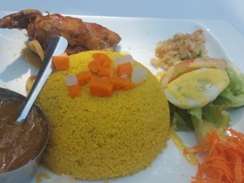 Thiéboudiène, a traditional Senegalese rice dish, usually served with fish, vegetables, and rice.