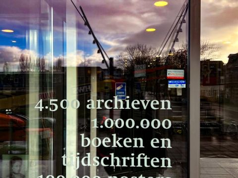 Text On The Door To The IISH, means 4,500 Archives, 1 Million Books and Magazines, 100 thousand posters in Dutch Photo Credit: Cherelle Karsseboom