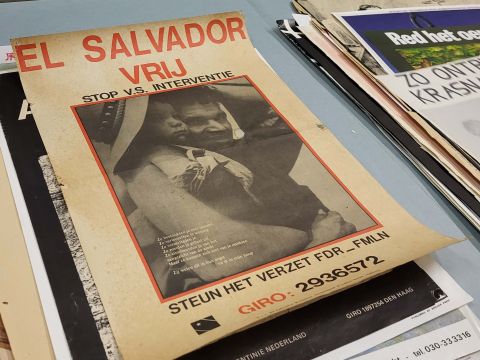 A Dutch protest poster with photograph of a father and a child in the center. In Dutch are the words "Free El Salvador" along with a poem discussing the power of hope.; Photo Credit: Enrico Joaquin Lapuz (2024)