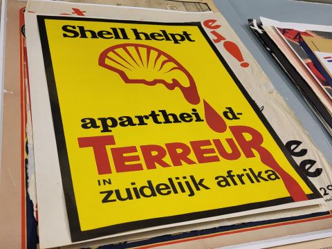 Anti-Shell poster with the Shell logo dripping blood into words critiquing their involvment with apartheid policies in South Africa; Photo Credit: Enrico Joaquin Lapuz (2024)