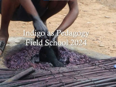 Man demonstrating indigo dyeing process in Daboya, Ghana while the title "Indigo as Pedgagogy Field School 2024" appears in white letters at the center of the screen; Credit: HAB and IAS Ghana