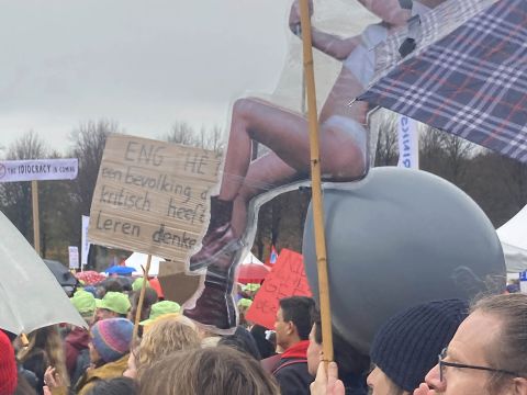 Eppo Bruins on wrecking ball. Sign reads: Scary, isn't it? A population that has learned to think critically. Photo: Marije ten Brink