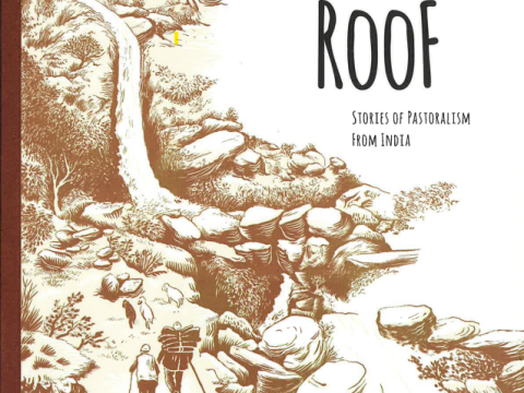 Book cover of "A World Without A Roof: Stories of Pastoralism From India". The book cover shows a long, winding, mountainous path next to a stream that two herders are moving up to with their animals.