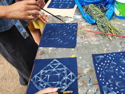 A few examples of the designs created by participants on the dyed indigo cloth. 
